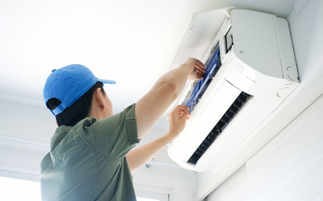 Air conditioning technician maintaining an indoor mini split system in Fort Collins, CO