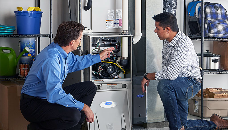 HVAC technician evaluating a furnace for repair or replacement in Fort Collins