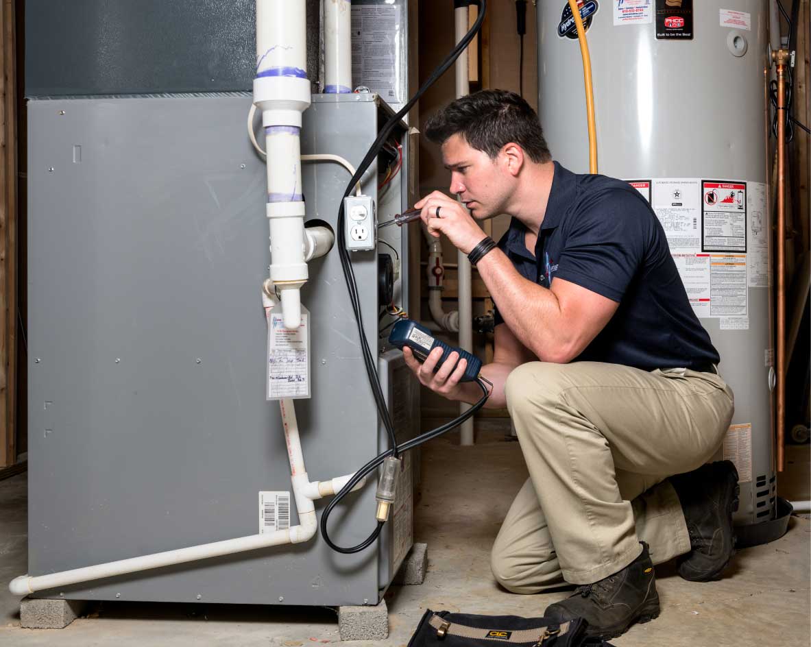 HVAC technician performing a furnace tune-up in Fort Collins